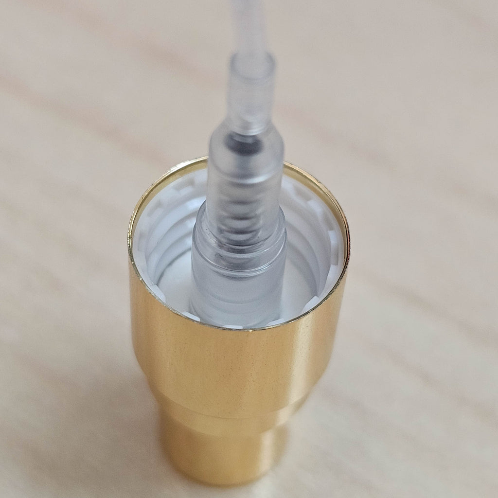 Close-up of the gold spray pump mechanism