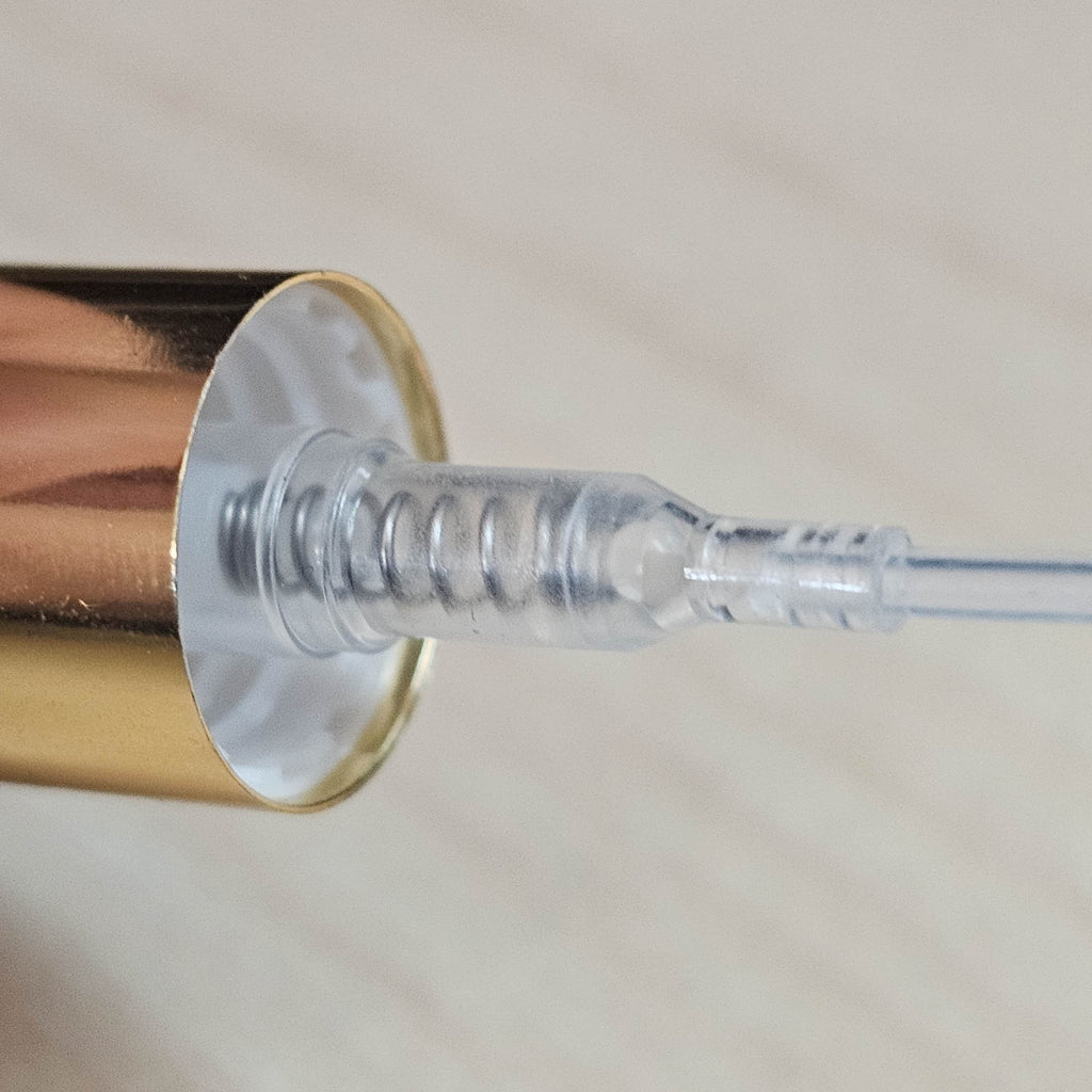 Gold atomizer pump and threaded neck detail