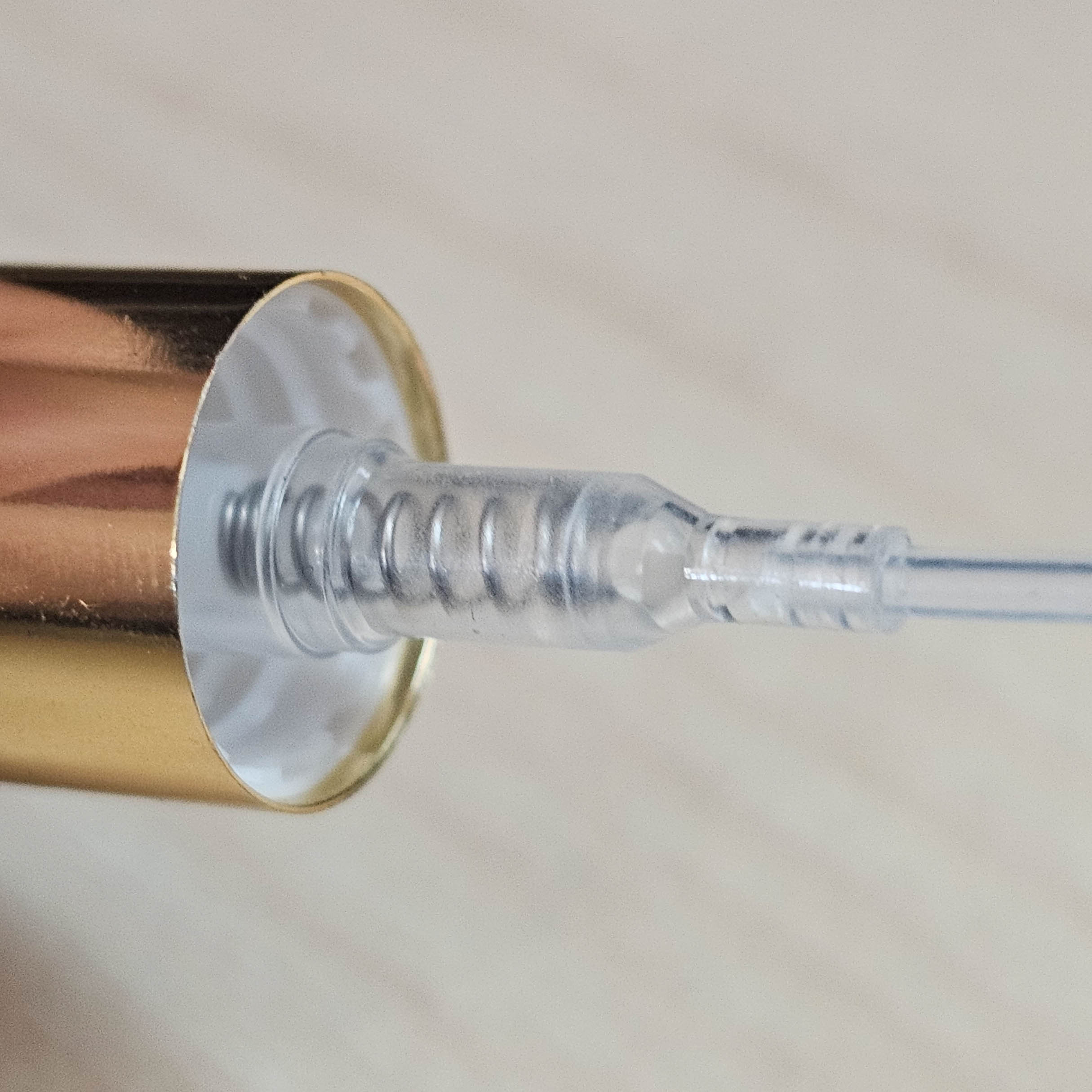 Gold atomizer pump and threaded neck detail