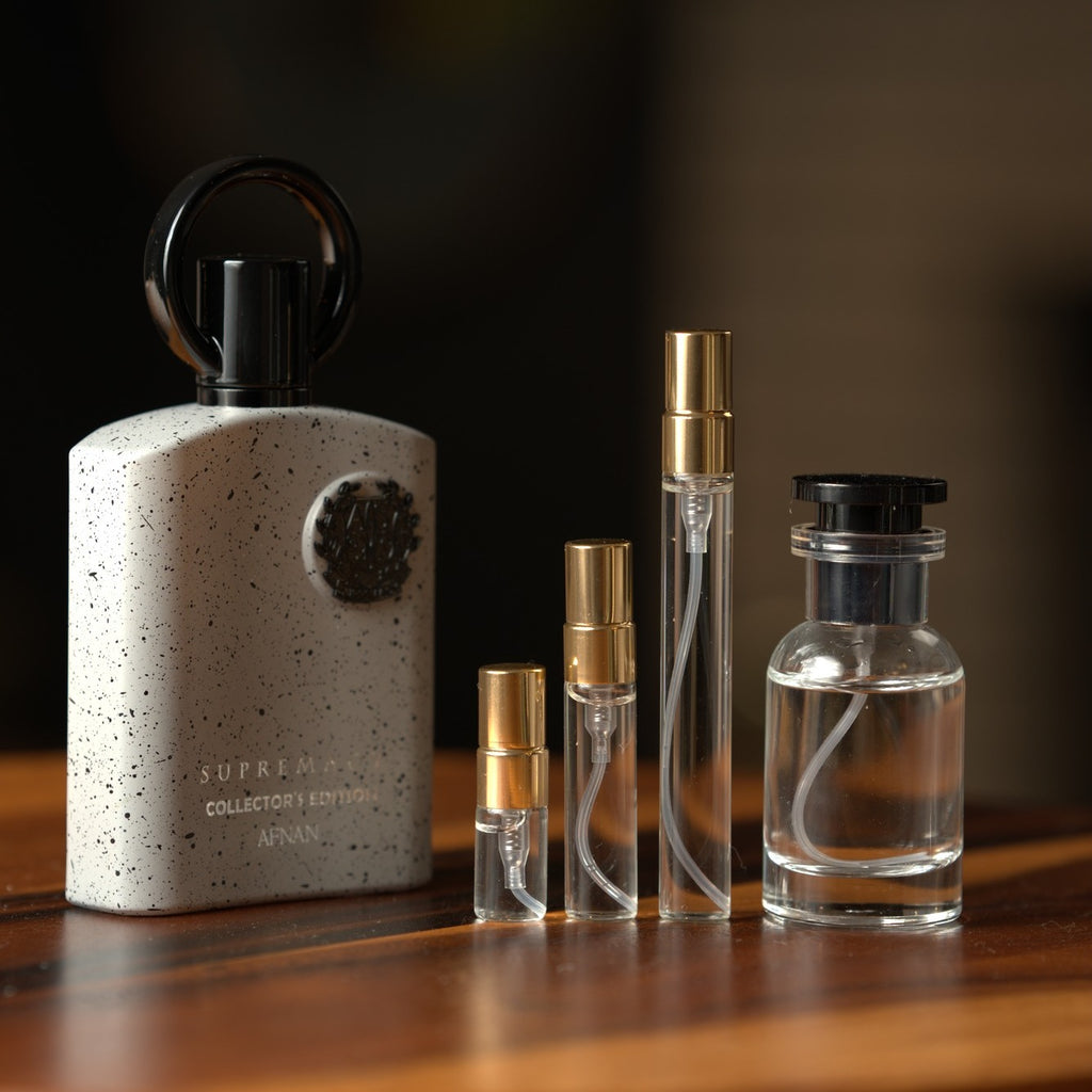 Afnan Supremacy Collector's Edition bottle with Atelier Elemental decant vials