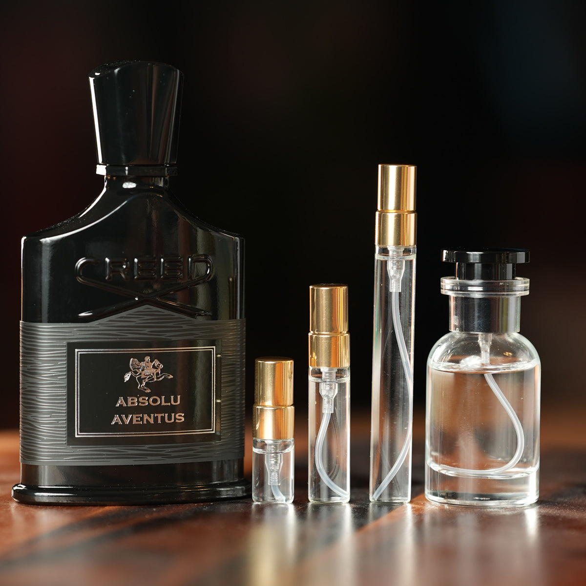 CREED ABSOLU AVENTUS perfume bottle beside decant vials