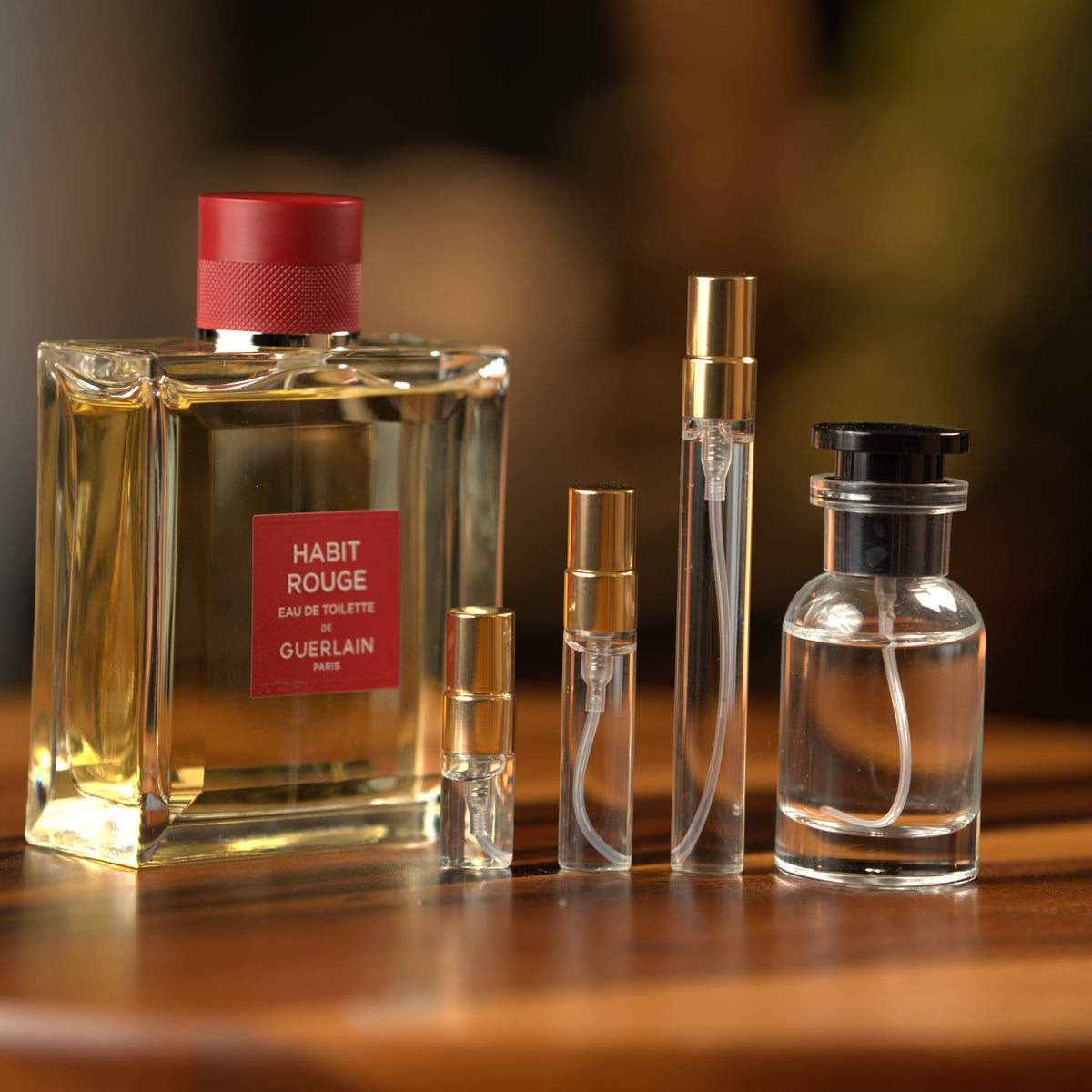 Guerlain Habit Rouge bottle with Atelier Elemental decant vials