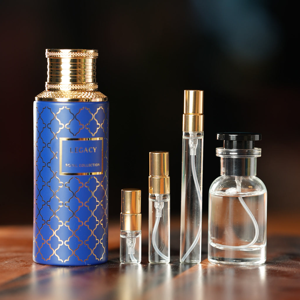 MAISON ASRAR LEGACY perfume bottle beside decant vials