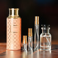 MAISON ASRAR MONARCH perfume bottle beside decant vials