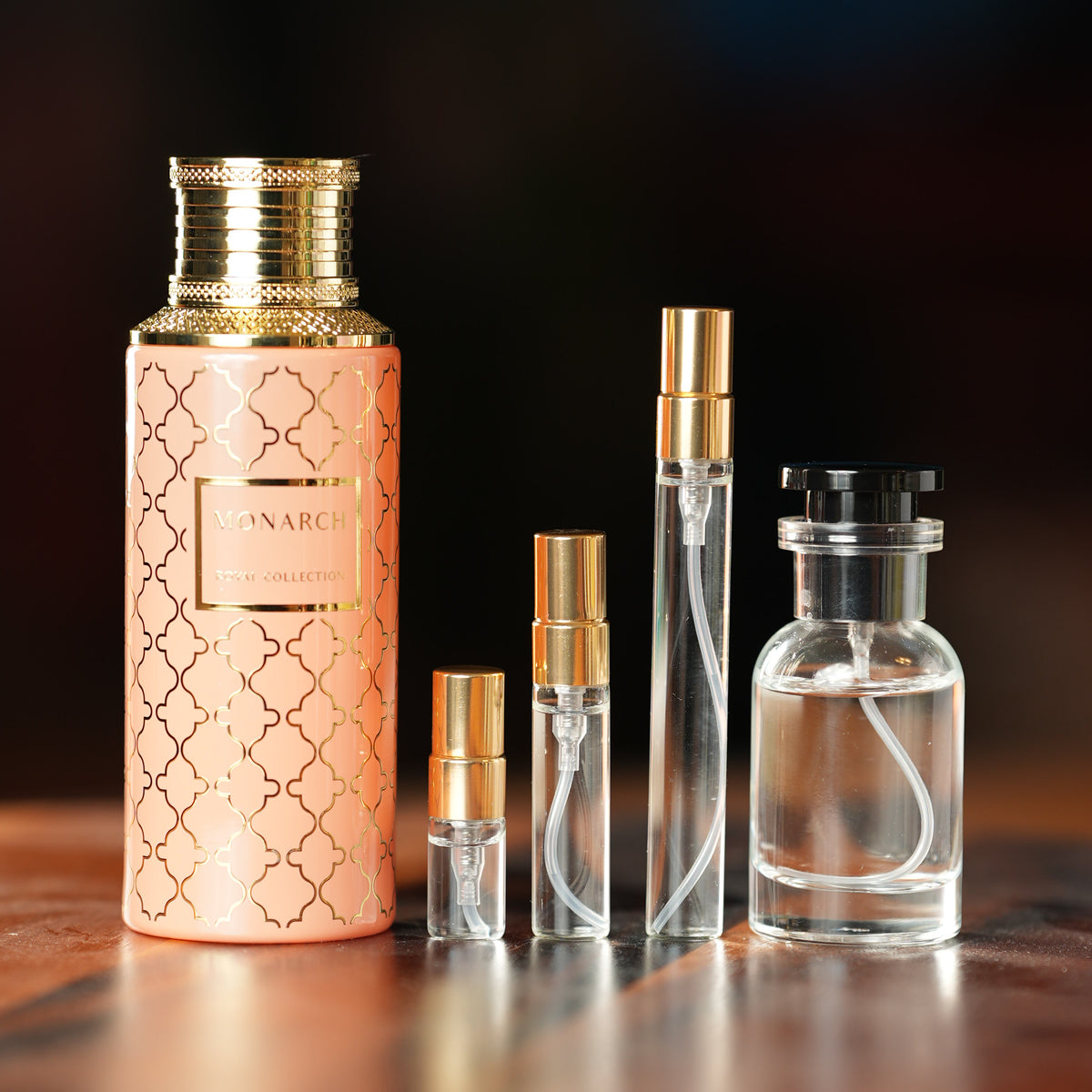 MAISON ASRAR MONARCH perfume bottle beside decant vials