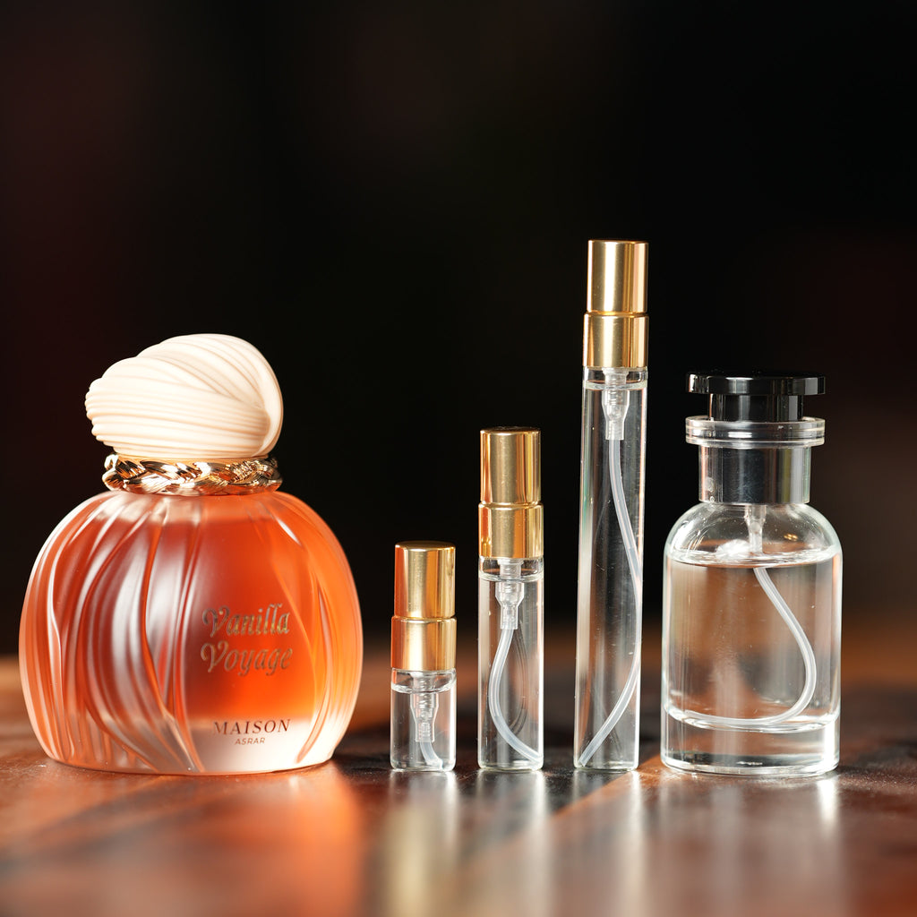 MAISON ASRAR VANILLA VOYAGE perfume bottle beside decant vials