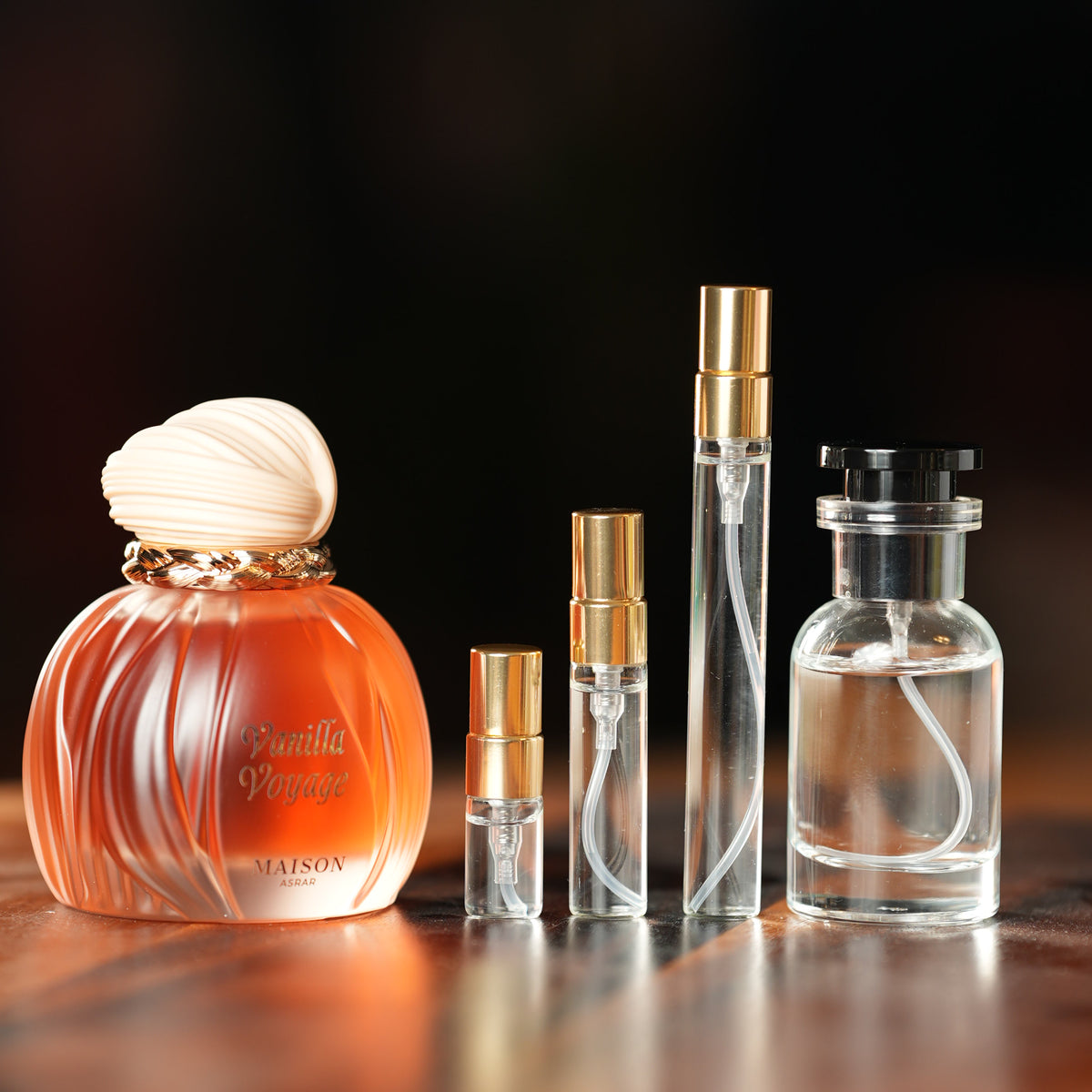 MAISON ASRAR VANILLA VOYAGE perfume bottle beside decant vials