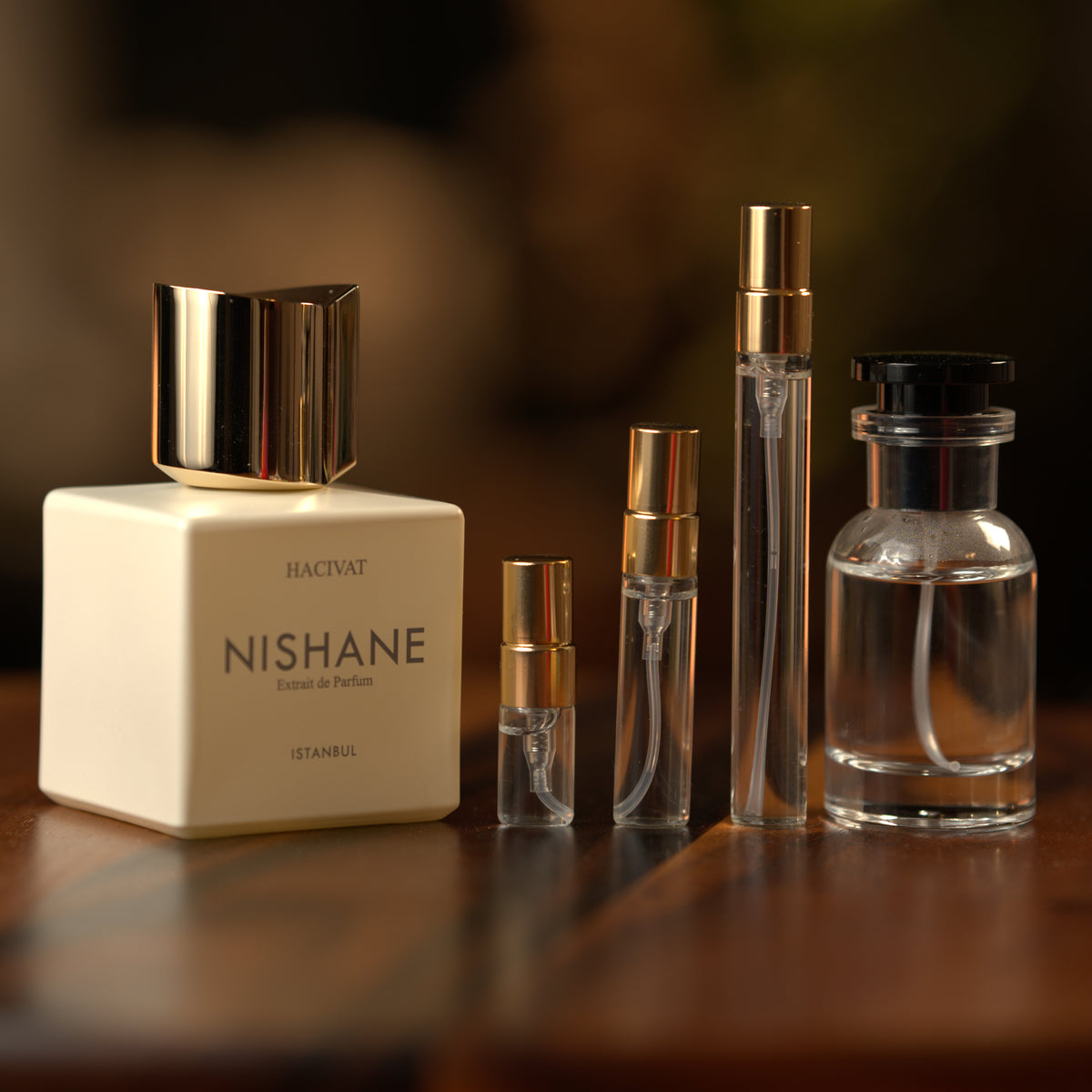 Nishane Hacivat extrait de parfum beside Atelier Elemental decant vials in 2 ml, 5 ml, 10 ml and 30 ml sizes