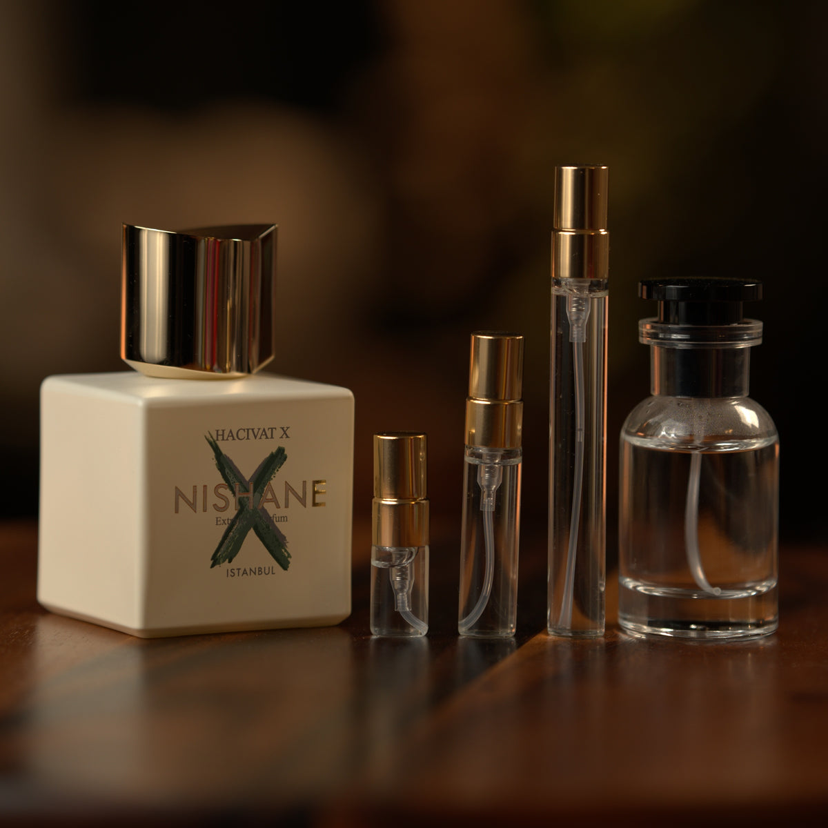 Nishane Hacivat X extrait de parfum beside Atelier Elemental decant vials in 2 ml, 5 ml, 10 ml and 30 ml sizes