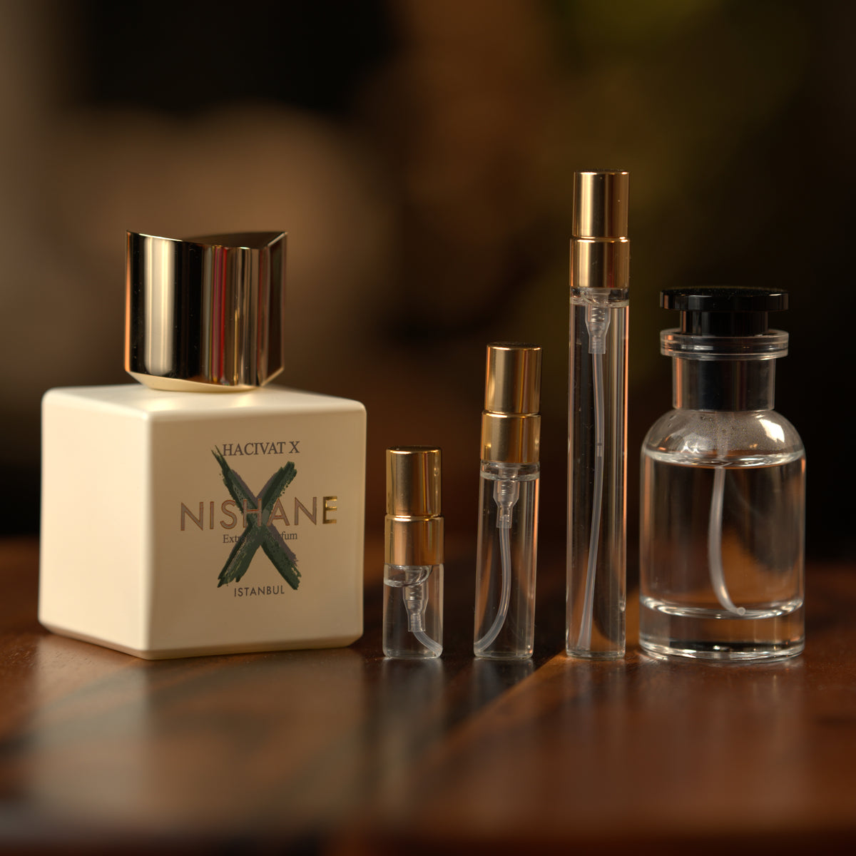 Nishane Hacivat X extrait de parfum beside Atelier Elemental decant vials in 2 ml, 5 ml, 10 ml and 30 ml sizes