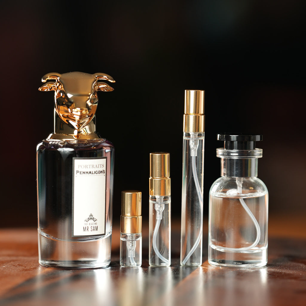 Penhaligon's The Blazing Mr Sam Eau de Parfum bottle beside Atelier Elemental decant vials