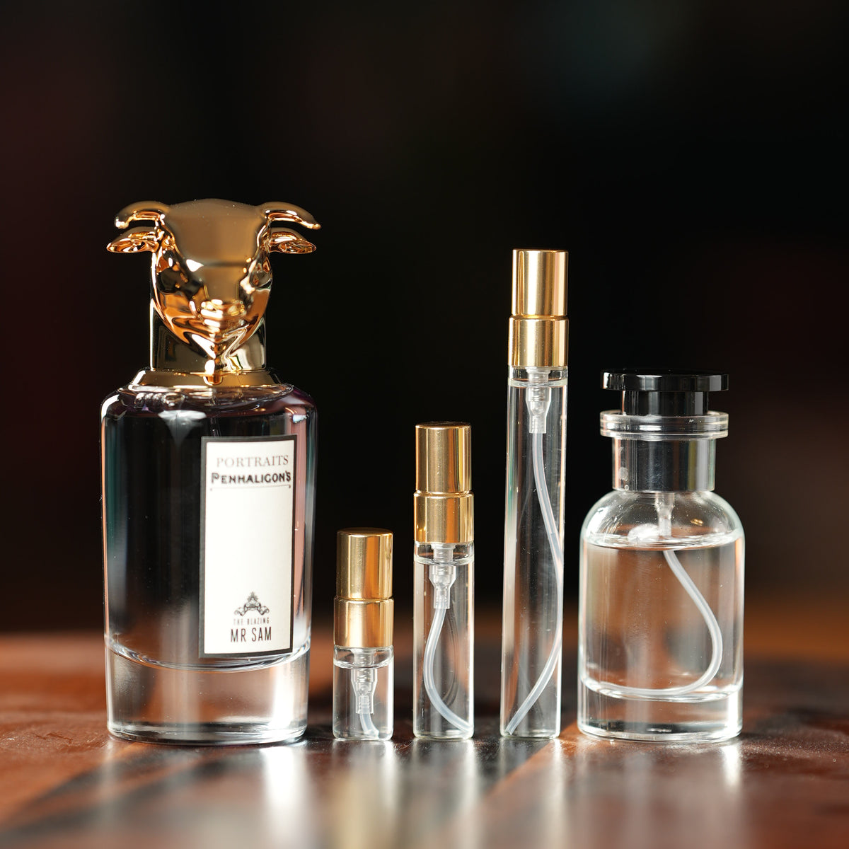 Penhaligon's The Blazing Mr Sam Eau de Parfum bottle beside Atelier Elemental decant vials