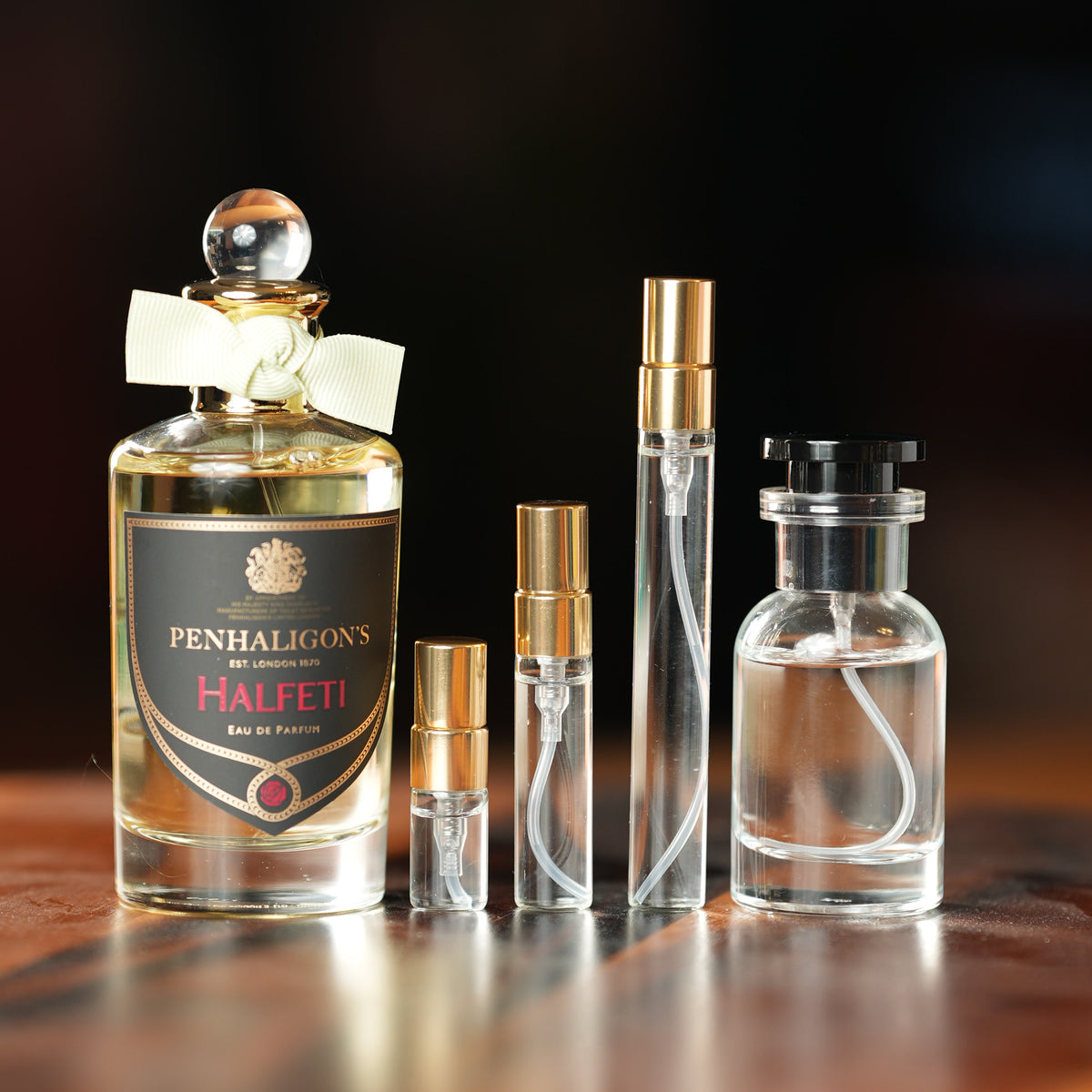 Penhaligon's Halfeti Eau de Parfum bottle beside Atelier Elemental decant vials