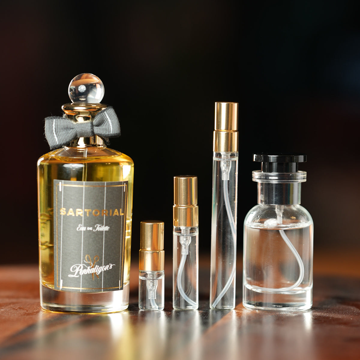 Penhaligon's Sartorial Eau de Toilette bottle beside Atelier Elemental decant vials