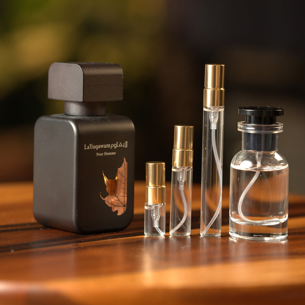 Rasasi La Yuqawam Pour Homme bottle with Atelier Elemental decant vials