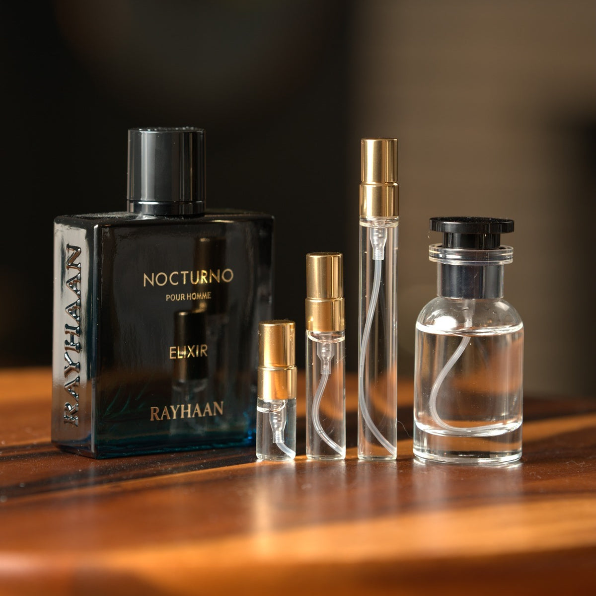 Rayhaan Nocturno Pour Homme Elixir bottle with Atelier Elemental decant vials