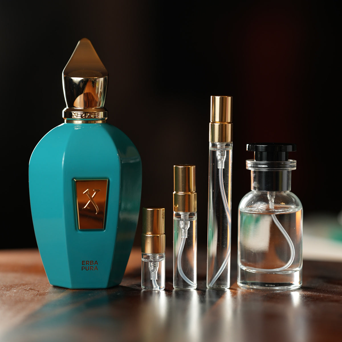 Xerjoff Erba Pura perfume bottle beside decant vials